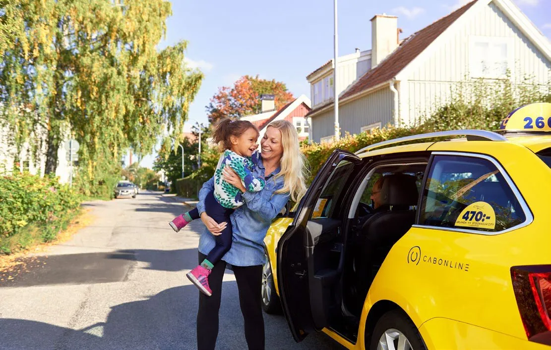 En familie ved siden af en Cabonline-taxa (foto: Cabonline)